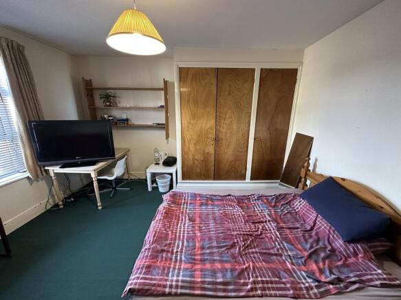 Bright double bedroom with large built-in wardr...