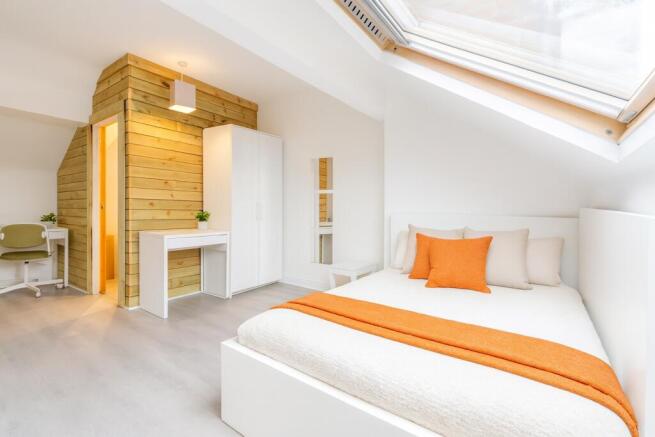 Bright and airy bedroom featuring a comfortable...