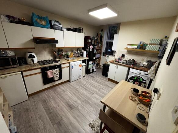 Bright, well-equipped kitchen with modern wood-...