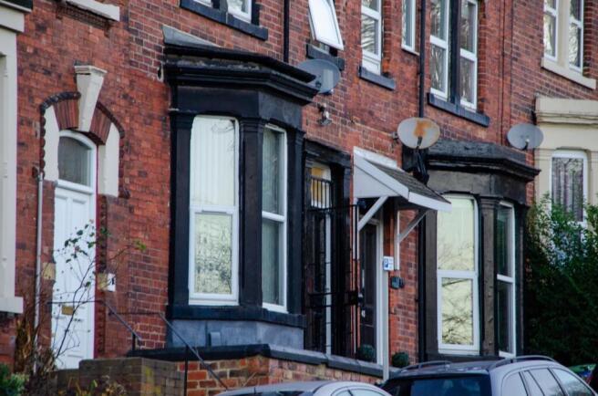 Charming brick exterior with classic bay window...