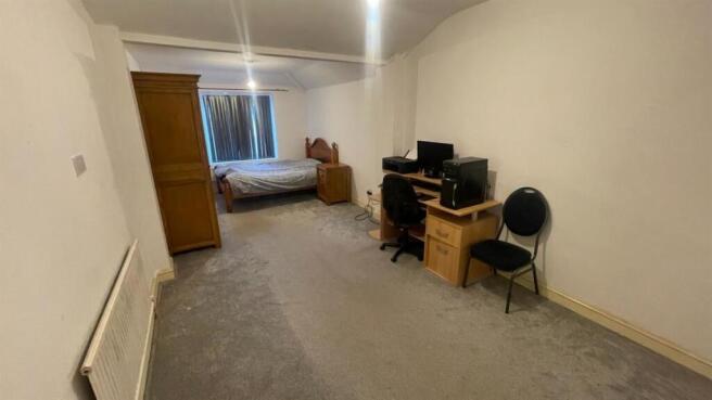 Spacious bedroom with dedicated workspace...