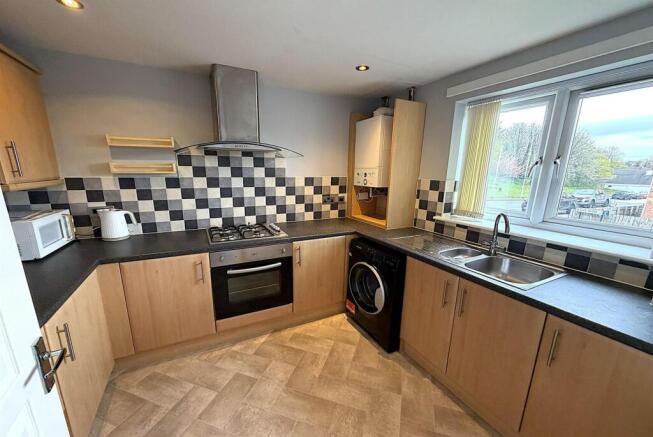 Modern kitchen with ample workspace and storage...