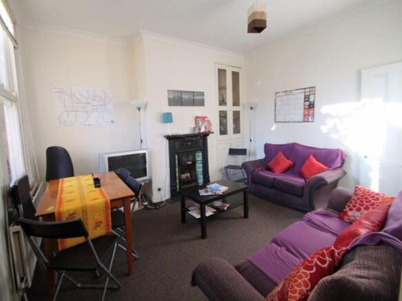 A spacious, bright living room with contemporar...