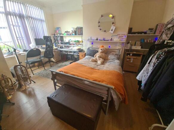 A spacious and well-lit master bedroom featurin...