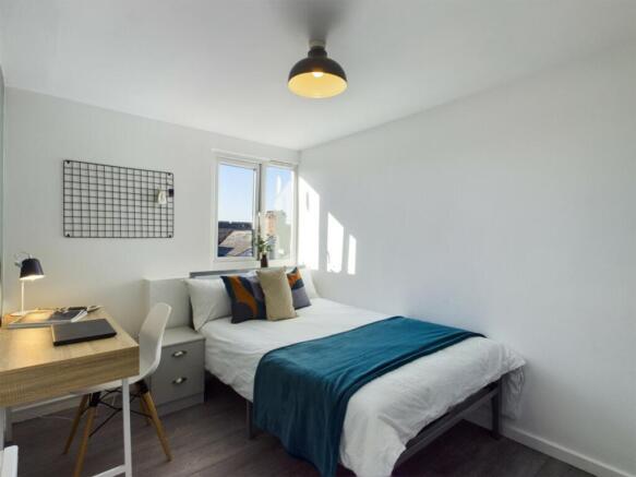 A bright and inviting double bedroom featuring ...
