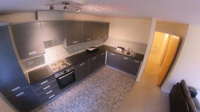 Modern galley kitchen with integrated oven, sle...