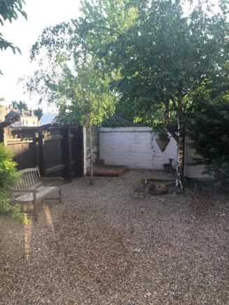 Private courtyard garden with brick outbuilding