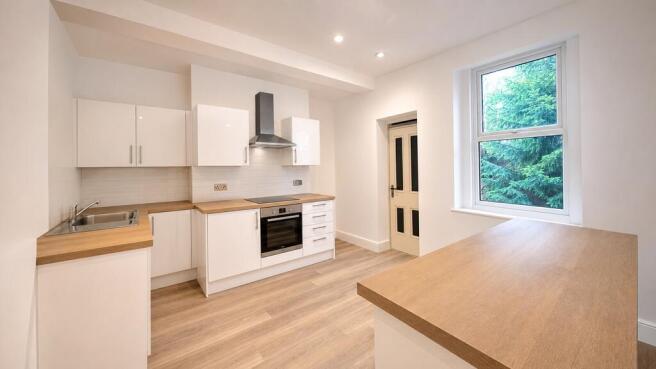 Modern bright kitchen with sleek white cabinets...
