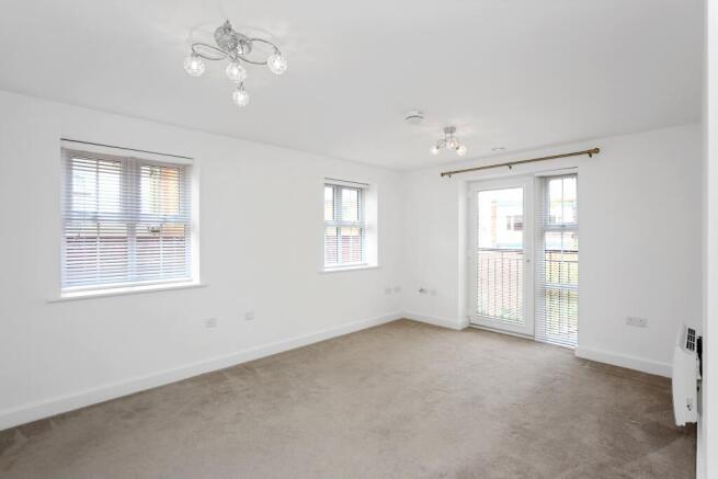 a room with a ceiling fan and windows