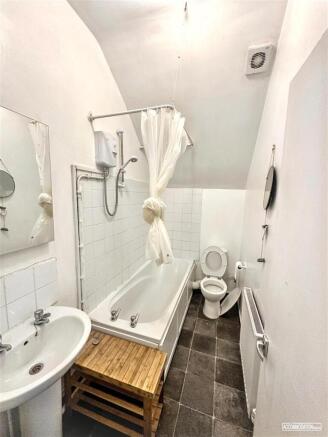 Bright bathroom suite with bathtub and shower...