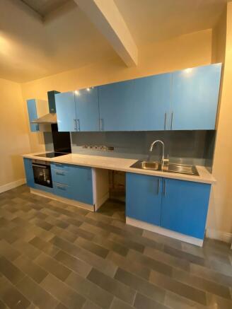 Modern vibrant blue kitchen with ample storage...
