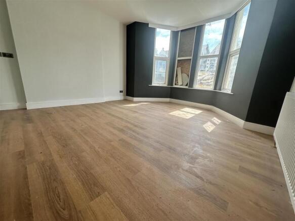 Sunlit living room with modern wood flooring...