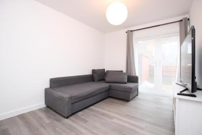 Bright, modern living room with a grey L-shaped...