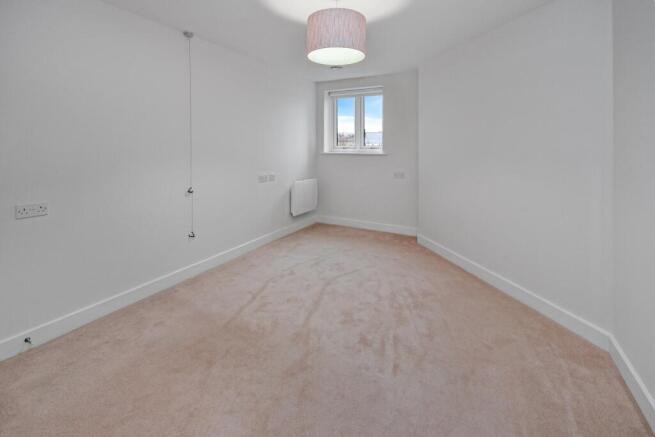 a room with a carpet and a light