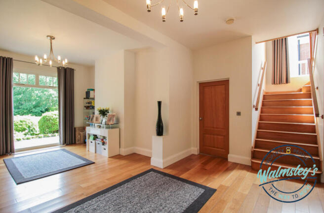 Hallway with staircase to first floor & balcony
