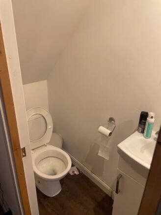 A tidy single toilet with essential amenities....