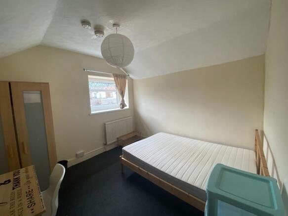 Bright bedroom with double bed and study desk...