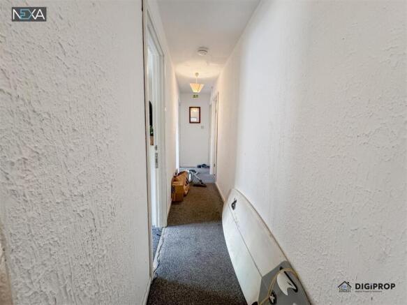 Bright and neutral hallway with soft carpeting...