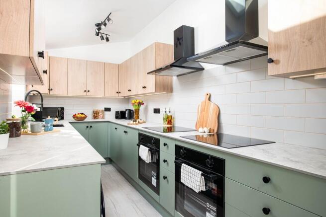 Modern, spacious kitchen with dual hobs and ove...