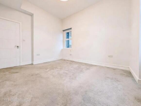 Bright, neutral single bedroom with fresh white...