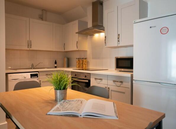 A bright and modern kitchenette equipped with e...