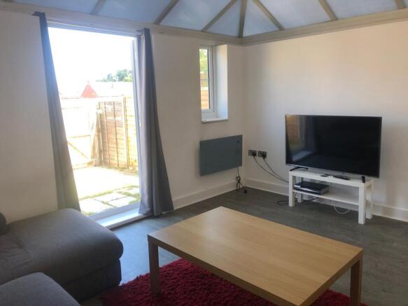 Bright, modern living room with large patio doo...