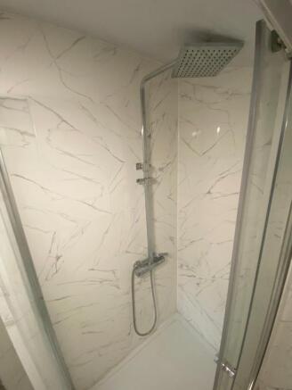 Modern bathroom shower area featuring stylish m...
