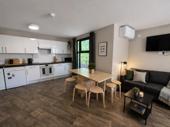 Bright open-plan kitchen with modern lounge are...