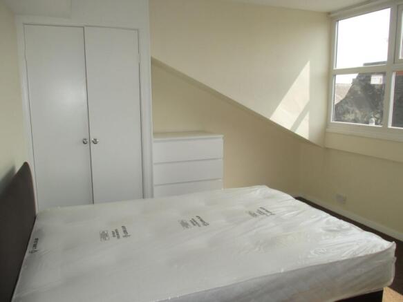Bright, neatly presented bedroom with a large w...