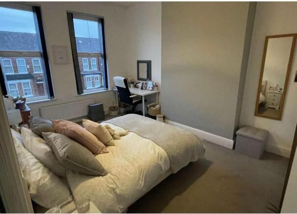 Bright, neatly presented master bedroom with a ...