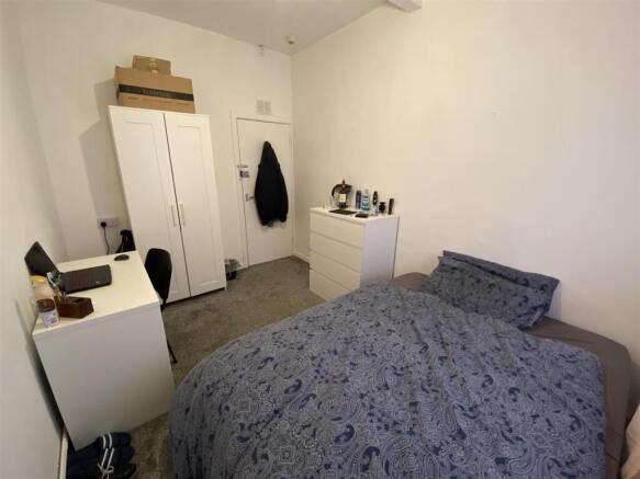 Bright bedroom with ample storage and study des...