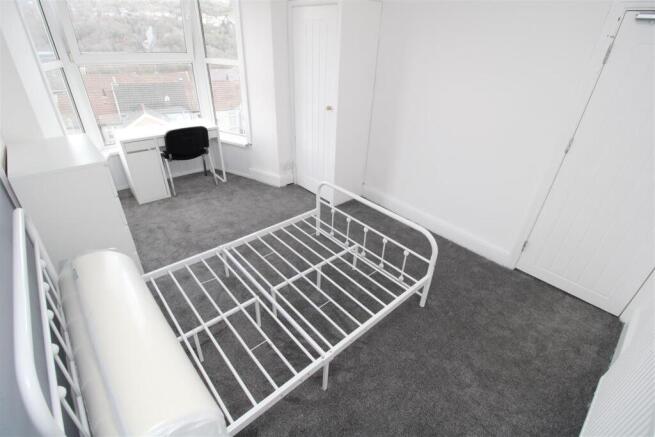 Bright modern bedroom with study desk and windo...