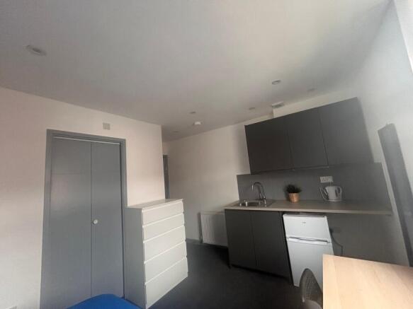 Compact studio with fitted kitchenette and stor...