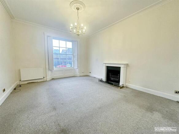 Bright spacious lounge with classic fireplace...