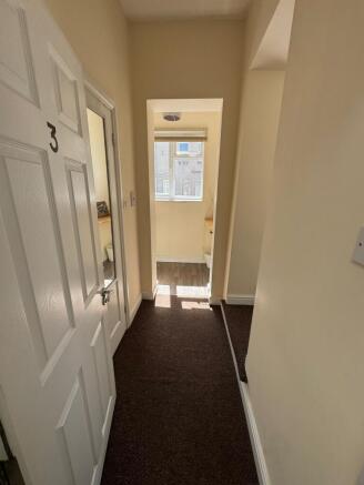 Bright hallway with warm carpet and natural lig...