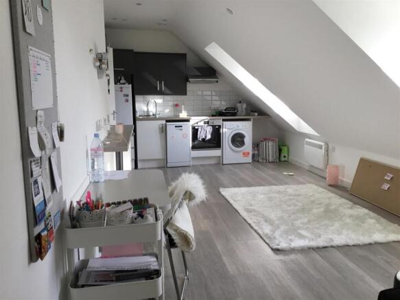 Bright modern studio with sleek kitchen area...