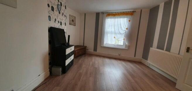 A bright and spacious living room with a large ...