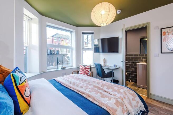 Bright, stylish double bedroom with a bay windo...