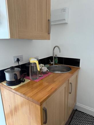 Bright kitchenette with warm wood finishes...