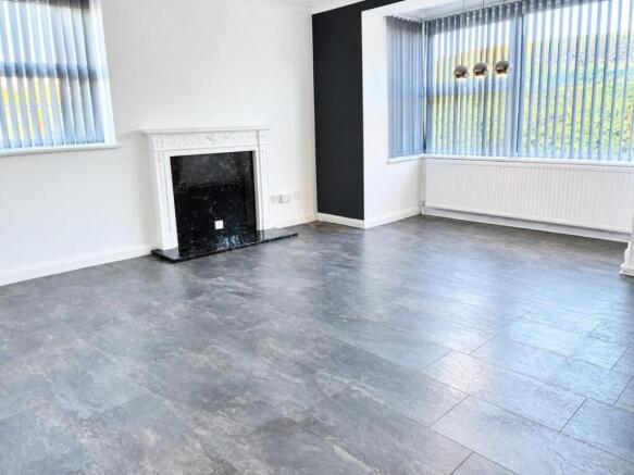 Bright Empty Living Room with Ornate Fireplace.jpg