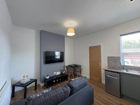 Contemporary open-plan living area with a wall-...