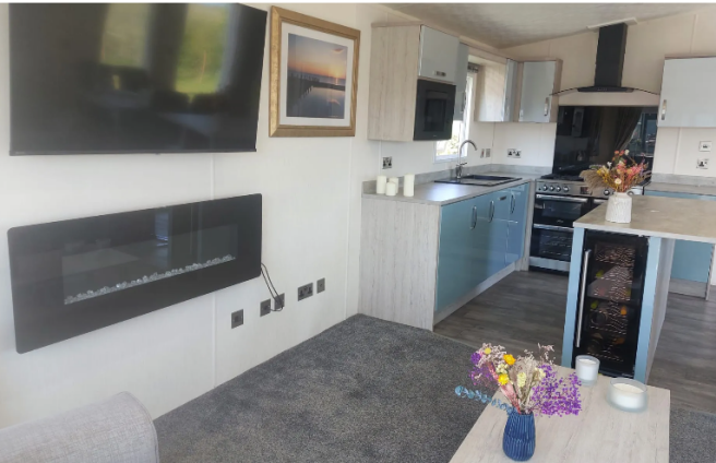 Open Plan Lounge And Kitchen With Feature Fireplac