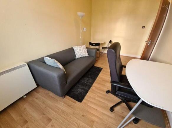 A cozy living area featuring a comfortable dark...