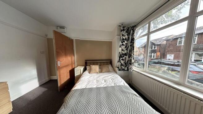 Bright and inviting bedroom with a large window...