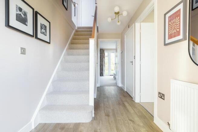 The central hallway has under stairs storage