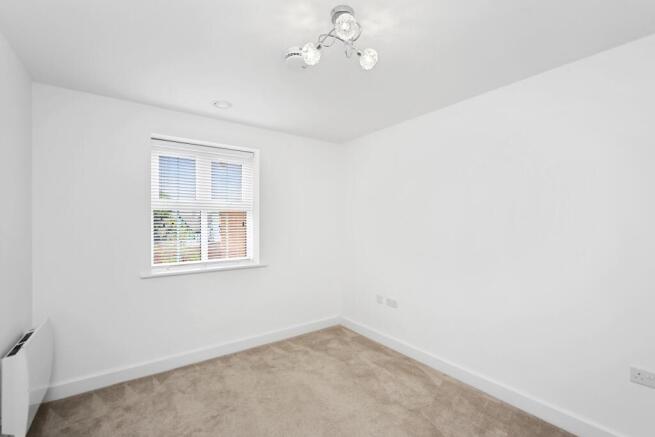 a room with a window and carpet