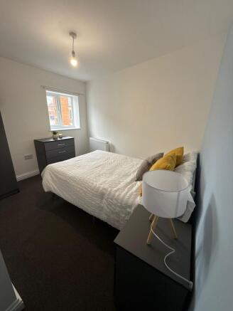 Bright, simply styled double bedroom with neutr...