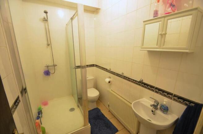 Well-maintained bathroom with a corner glass sh...