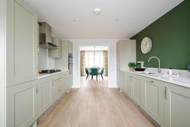 The kitchen leads through to the dining area with double doors to the garden