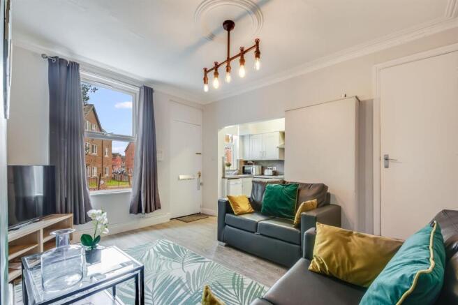 Bright, stylish living room with large window, ...